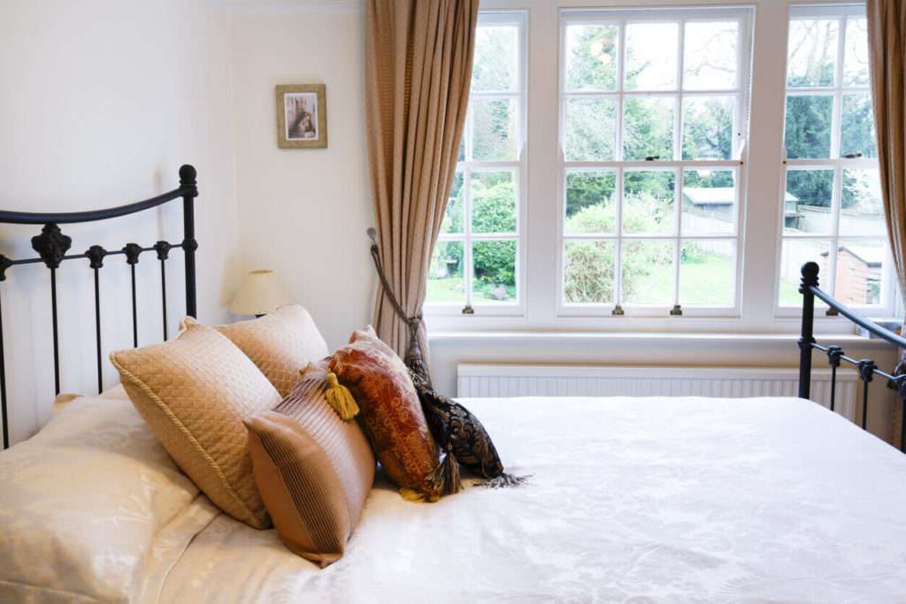 Period home bedroom with feature wooden timber sash window