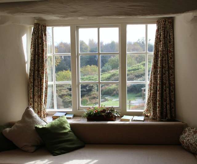 window seat in front of window looking out over fields and trees