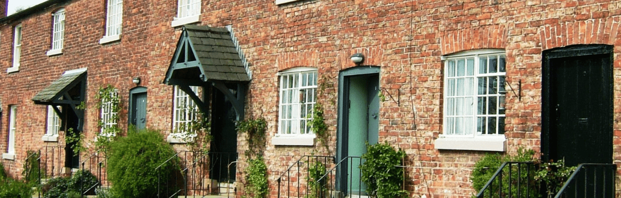 Terraced Cottages with Timber Sash Windows Row of brick terraced cottages with white timber sash windows